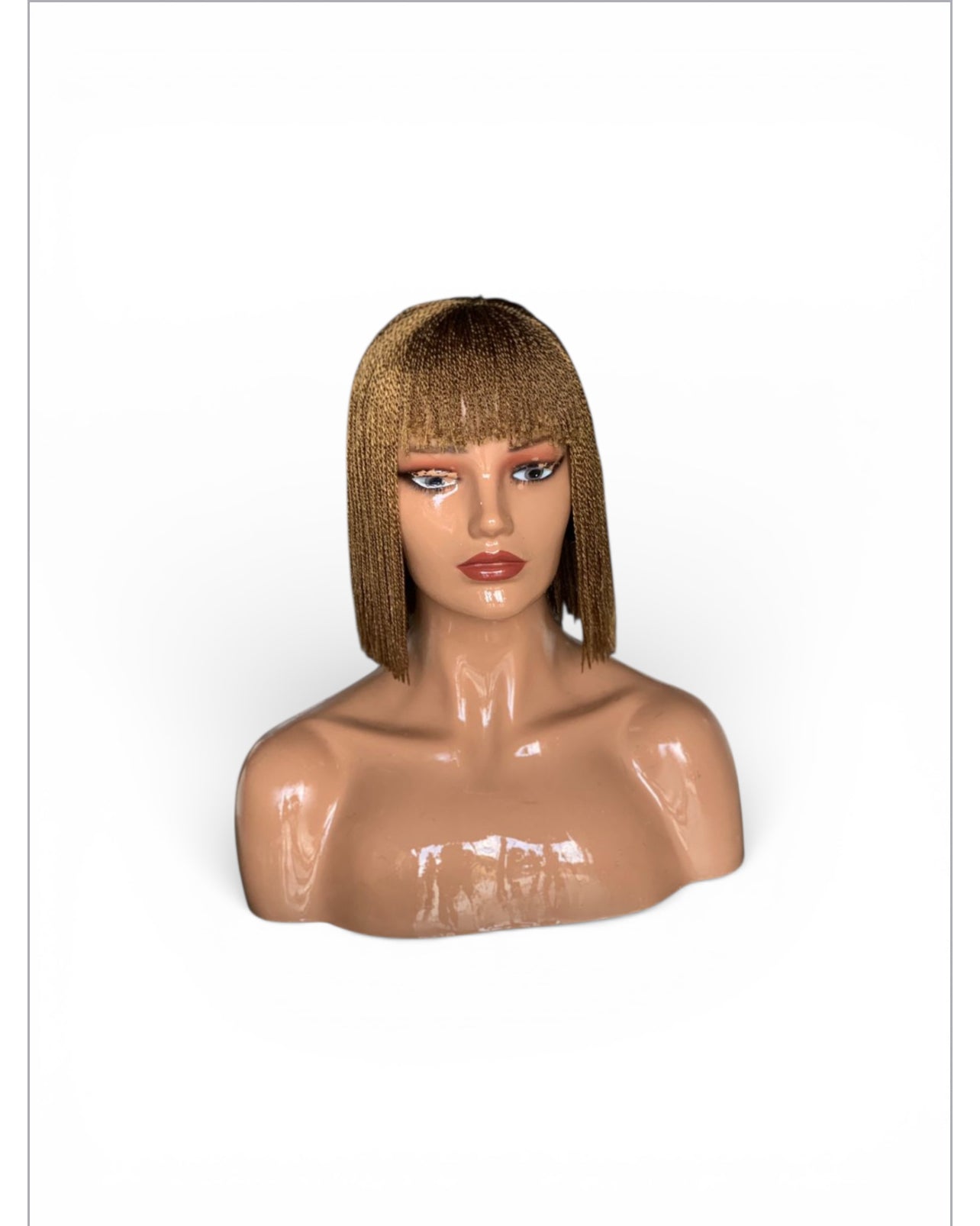 Bangs Twist wig in golden blonde with straight bangs and twist texture; lightweight, lace pre-tinted, no cutting.
