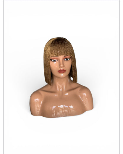 Bangs Twist wig in golden blonde with straight bangs and twist texture; lightweight, lace pre-tinted, no cutting.